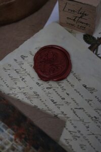 A red wax seal on a letter.